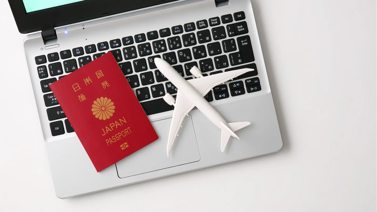 Passport, model aircraft and travel documents on a desk