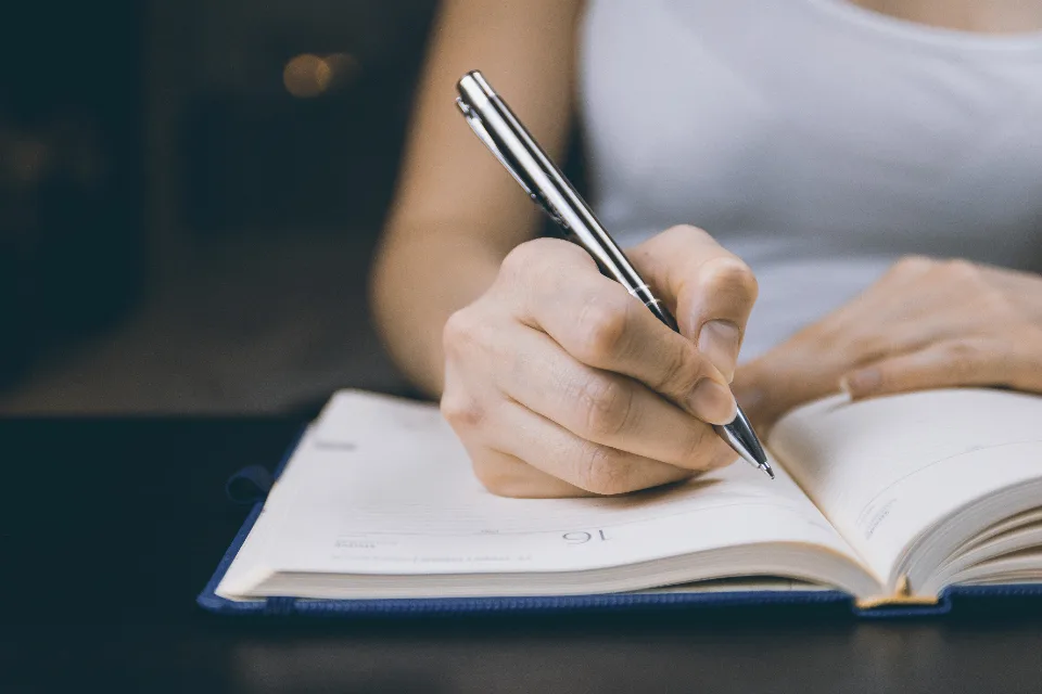 Person writing out personal details by hand