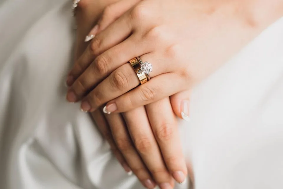 Hands with a wedding ring, for a passport name change after marriage