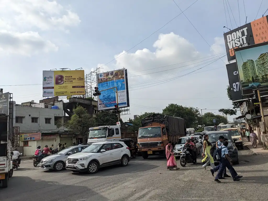 Cars, trucks and two-wheelers at a busy Pune junction