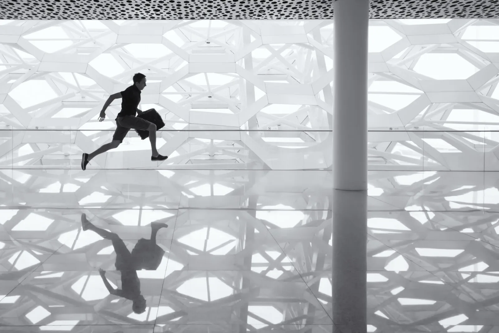 Traveller running through an airport terminal against the clock
