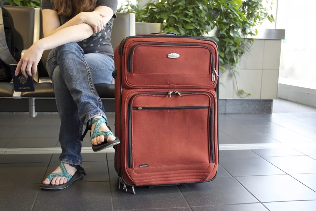 Traveller waiting with a suitcase before an international trip