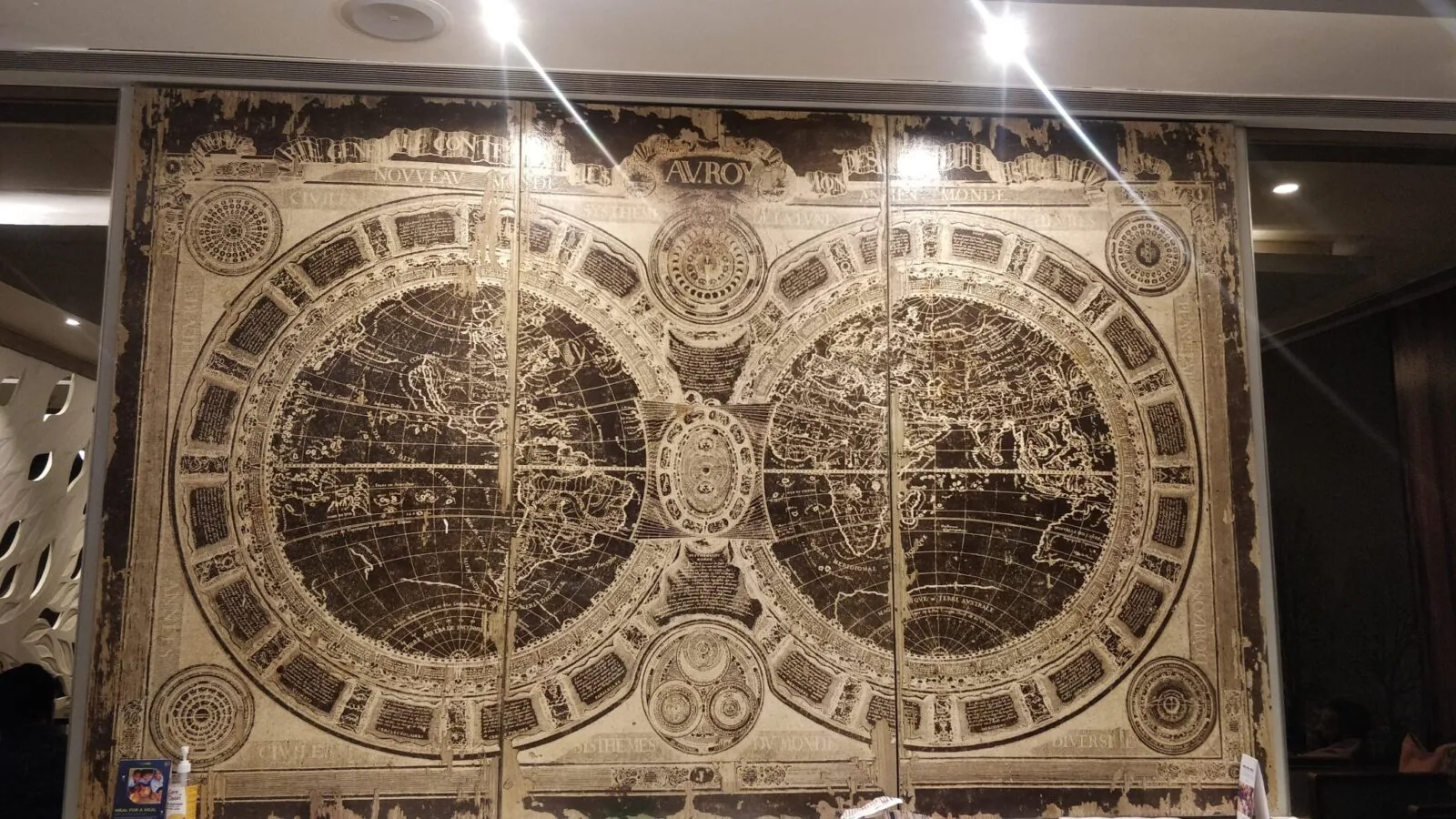 A large world map on an airport wall