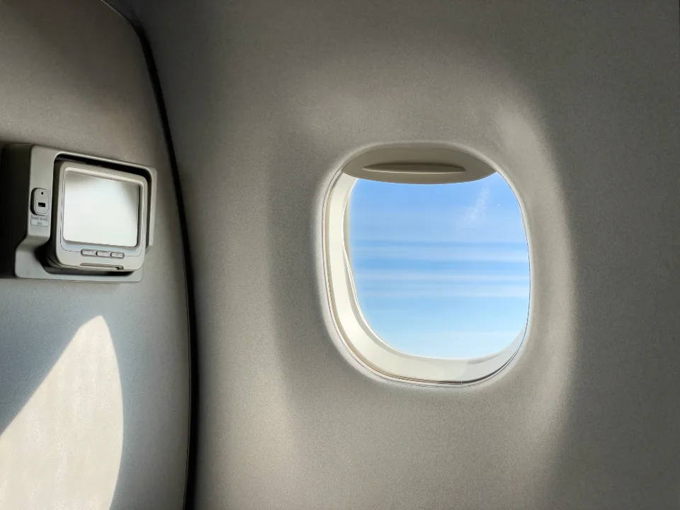 Airplane window on an international flight